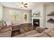 Inviting living room with fireplace, ceiling fan, wood floors, and a view to the backyard at 178 Cullen Ct, Clayton, NC 27520