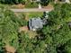 Aerial view of this home showcasing its roof line and the lush trees surrounding it at 188 E Antebellum Dr, Pittsboro, NC 27312