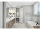 This bathroom features double sinks, marble countertops, a soaking tub, and a window for natural light at 188 E Antebellum Dr, Pittsboro, NC 27312