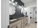 Stylish bathroom with double vanities, round mirrors, and a door, blending modern design with functionality at 188 E Antebellum Dr, Pittsboro, NC 27312