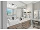 This bathroom features double sinks, marble countertops, and a window for natural light at 188 E Antebellum Dr, Pittsboro, NC 27312
