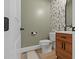 Powder room featuring floral wallpaper and a modern vanity at 188 E Antebellum Dr, Pittsboro, NC 27312