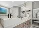 This bathroom features double sinks, marble countertops, and a window for natural light at 188 E Antebellum Dr, Pittsboro, NC 27312