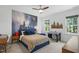 Charming bedroom featuring an accent wall, ceiling fan, and two windows, offering ample natural light at 188 E Antebellum Dr, Pittsboro, NC 27312