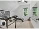 Bright exercise room with workout equipment, a large mirror, and a window with a view at 188 E Antebellum Dr, Pittsboro, NC 27312