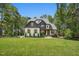 Stunning two-story home boasts a well-manicured lawn, mature trees, and inviting curb appeal at 188 E Antebellum Dr, Pittsboro, NC 27312