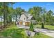 A luxury home featuring a manicured lawn, elegant driveway, and attached garages at 188 E Antebellum Dr, Pittsboro, NC 27312