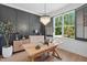 Bright home office featuring a modern chandelier, large window, and wood desk at 188 E Antebellum Dr, Pittsboro, NC 27312