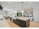 Open kitchen featuring an island with a sink and granite countertops at 188 E Antebellum Dr, Pittsboro, NC 27312