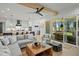 Open-concept living room flows to the kitchen, features a ceiling fan and deck access at 188 E Antebellum Dr, Pittsboro, NC 27312