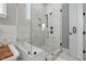 The bathroom has a sleek glass enclosed shower with marble-look tile and a built-in seat at 188 E Antebellum Dr, Pittsboro, NC 27312
