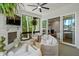 The relaxing sun room has large windows with views of mature trees and an outdoor living area at 188 E Antebellum Dr, Pittsboro, NC 27312