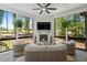 Cozy sunroom with a stone fireplace, mounted TV, and comfortable seating at 188 E Antebellum Dr, Pittsboro, NC 27312