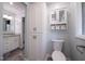 Bathroom features a toilet, storage cabinet, and a granite vanity, showcasing functionality and storage at 206 Rochelle Dr, Knightdale, NC 27545