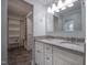 Bathroom featuring a double sink vanity, a walk-in closet, and tiled floors at 206 Rochelle Dr, Knightdale, NC 27545