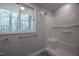 Bathroom featuring a shower, window, and towel rack at 206 Rochelle Dr, Knightdale, NC 27545