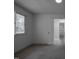 Spacious bedroom with neutral carpet, a closet, and window offering ample natural light at 206 Rochelle Dr, Knightdale, NC 27545