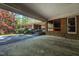 Spacious carport featuring a covered entryway, brick accents, and adjacent landscaping at 206 Rochelle Dr, Knightdale, NC 27545