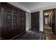 Inviting foyer featuring dark wood doors, wood flooring, and neutral-toned walls at 206 Rochelle Dr, Knightdale, NC 27545