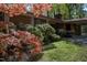 Well-manicured front yard showcasing a red brick home, mature trees, and lush greenery at 206 Rochelle Dr, Knightdale, NC 27545