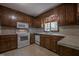 Kitchen featuring traditional wood cabinets, white appliances and tile flooring at 206 Rochelle Dr, Knightdale, NC 27545
