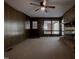 Living room featuring a brick fireplace, wood paneling, and carpeted flooring at 206 Rochelle Dr, Knightdale, NC 27545