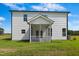 Exterior view of the home featuring a screened-in porch and well-maintained yard at 21 Green Links Dr, Cameron, NC 28326