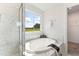 Bright bathroom features a glass shower, a soaking tub, and a walk-in closet at 21 Green Links Dr, Cameron, NC 28326