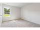 Bright bedroom featuring neutral carpeting and a large window with outdoor views at 21 Green Links Dr, Cameron, NC 28326