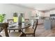 Dining area with a table for four, adjacent to the kitchen and patio access at 21 Green Links Dr, Cameron, NC 28326