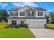Beautiful two-story home featuring stone accents, a two-car garage, and a manicured front lawn at 21 Green Links Dr, Cameron, NC 28326