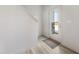 Bright foyer featuring wood-look floors, white walls, and a door to the outside at 21 Green Links Dr, Cameron, NC 28326