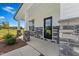 Inviting covered porch with stone columns and a modern front door with glass panel at 21 Green Links Dr, Cameron, NC 28326