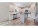 Modern kitchen with white cabinets, stainless steel appliances, and a gray kitchen island at 21 Green Links Dr, Cameron, NC 28326
