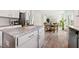 Open-concept kitchen with stainless steel appliances, island seating, and view into the living spaces at 21 Green Links Dr, Cameron, NC 28326