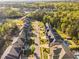 Overhead image capturing a residential street lined with houses, showcasing the neighborhood's layout and greenery at 212 Blue Granite Dr, Holly Springs, NC 27540