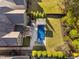 An aerial view of the backyard features a pool, patio, lush lawn and well-manicured landscaping at 212 Blue Granite Dr, Holly Springs, NC 27540