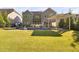 Expansive backyard featuring a pool, pergola, and a slide, creating an outdoor oasis for relaxation at 212 Blue Granite Dr, Holly Springs, NC 27540