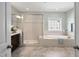 Luxurious bathroom featuring a walk-in shower, soaking tub, and elegant tile work, creating a spa-like experience at 212 Blue Granite Dr, Holly Springs, NC 27540
