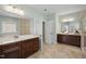 Elegant bathroom with double vanities, tile flooring, and a separate shower area, providing a functional and stylish space at 212 Blue Granite Dr, Holly Springs, NC 27540
