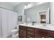 Bathroom features double sink vanity, shower with curtain, and neutral walls at 212 Blue Granite Dr, Holly Springs, NC 27540
