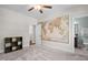 Cozy bedroom featuring carpet flooring, ceiling fan, and world map wall art with bathroom access at 212 Blue Granite Dr, Holly Springs, NC 27540