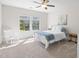 Bedroom features natural light with a metal frame bed and white rocking chair at 212 Blue Granite Dr, Holly Springs, NC 27540