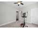 Bedroom features an elliptical machine, neutral walls, carpet and a ceiling fan at 212 Blue Granite Dr, Holly Springs, NC 27540