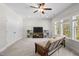 Bonus room features windows, ceiling fan, futon, TV, and large closet at 212 Blue Granite Dr, Holly Springs, NC 27540