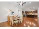 Bright open-concept dining area with kitchen views, hardwood floors, and stairs nearby at 212 Blue Granite Dr, Holly Springs, NC 27540