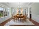 Formal dining room features a tray ceiling, hardwood floors, and ample natural light at 212 Blue Granite Dr, Holly Springs, NC 27540