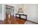 Foyer with hardwood floors, white trim, and neutral paint with views into other rooms at 212 Blue Granite Dr, Holly Springs, NC 27540