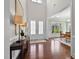Bright foyer with wood floors, high ceilings, and a view into the dining room at 212 Blue Granite Dr, Holly Springs, NC 27540