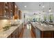 Gourmet kitchen with stainless appliances, granite counters, and view to the Gathering room at 212 Blue Granite Dr, Holly Springs, NC 27540